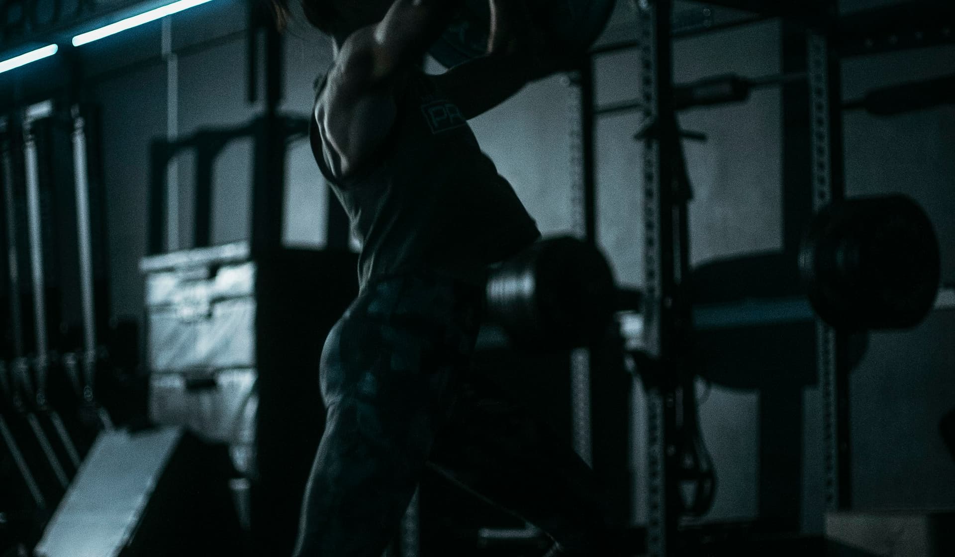 A lifter between sets in a dark gym